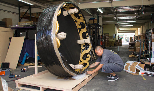 a person carefully packaging an auction item - City Business Shipping