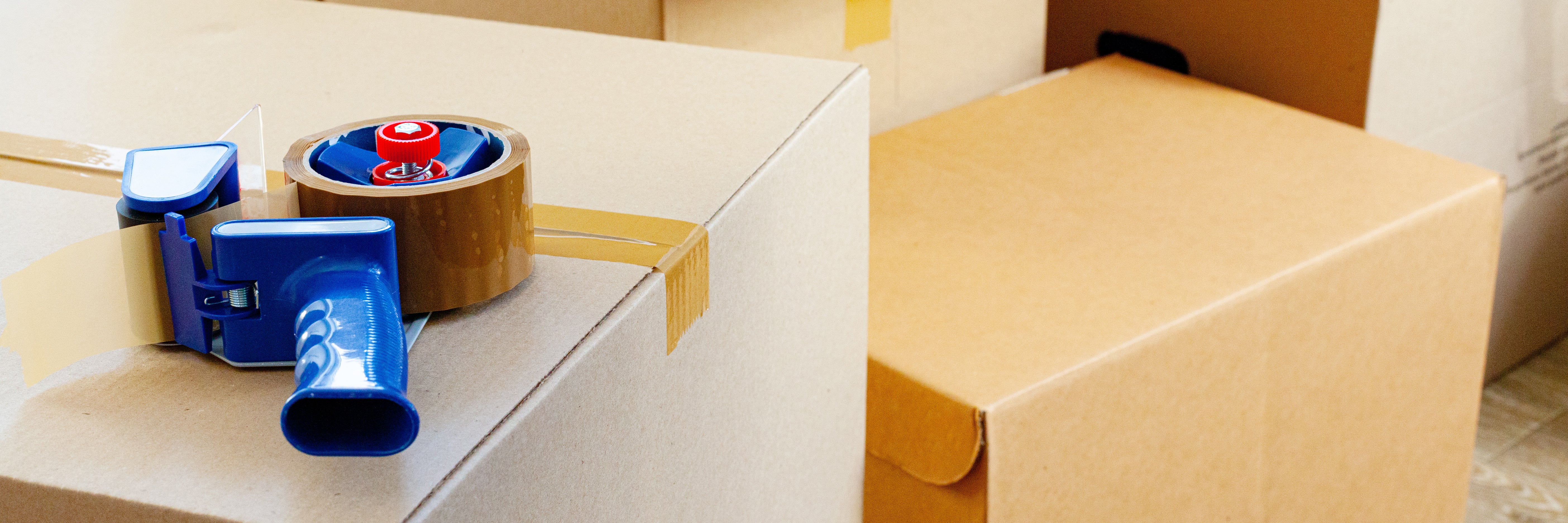 boxes with a tape gun resting on top- City Business Shipping