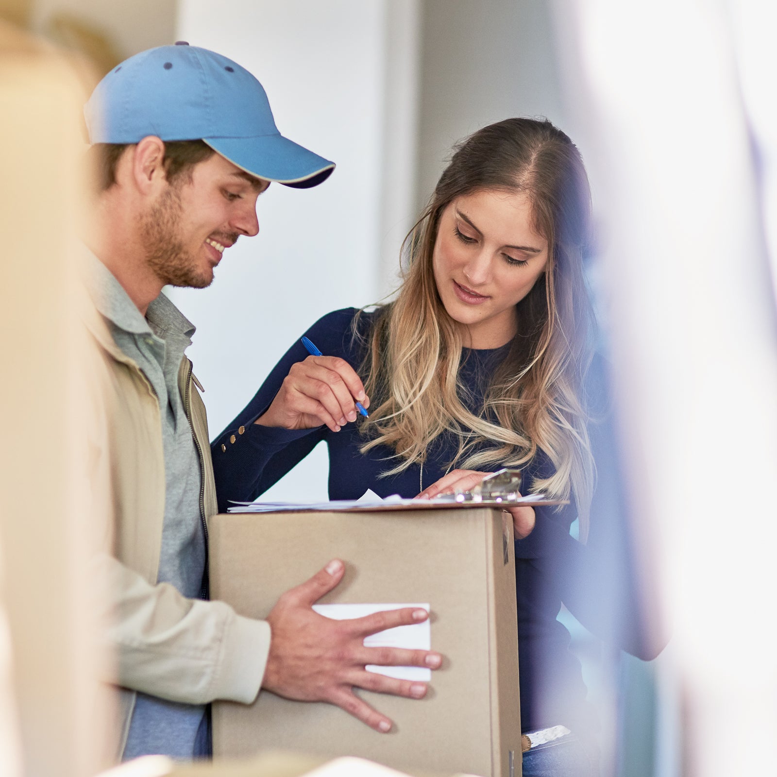 a man delivering a package to a woman- City Business Shipping